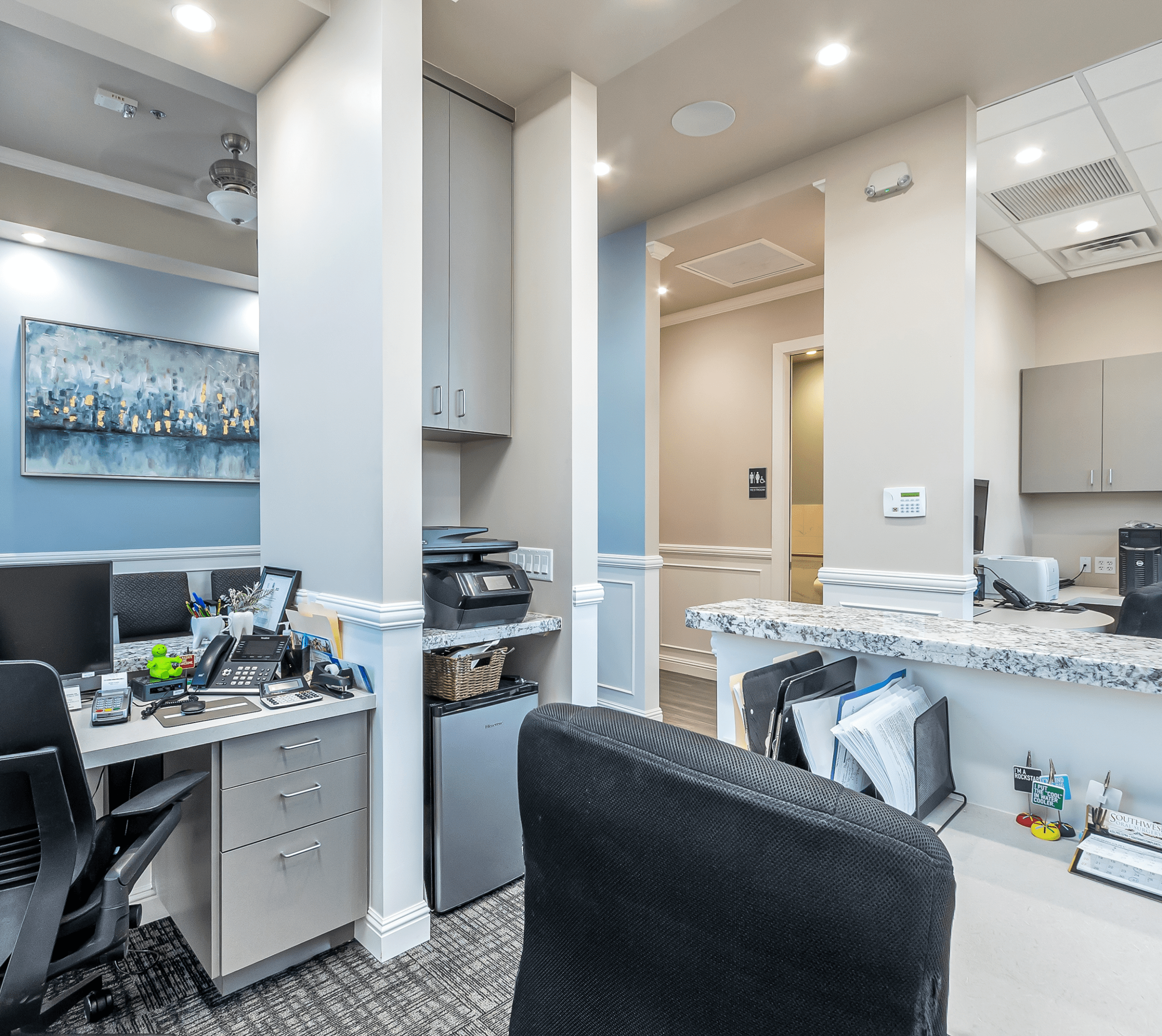 Office reception area with desks and chairs