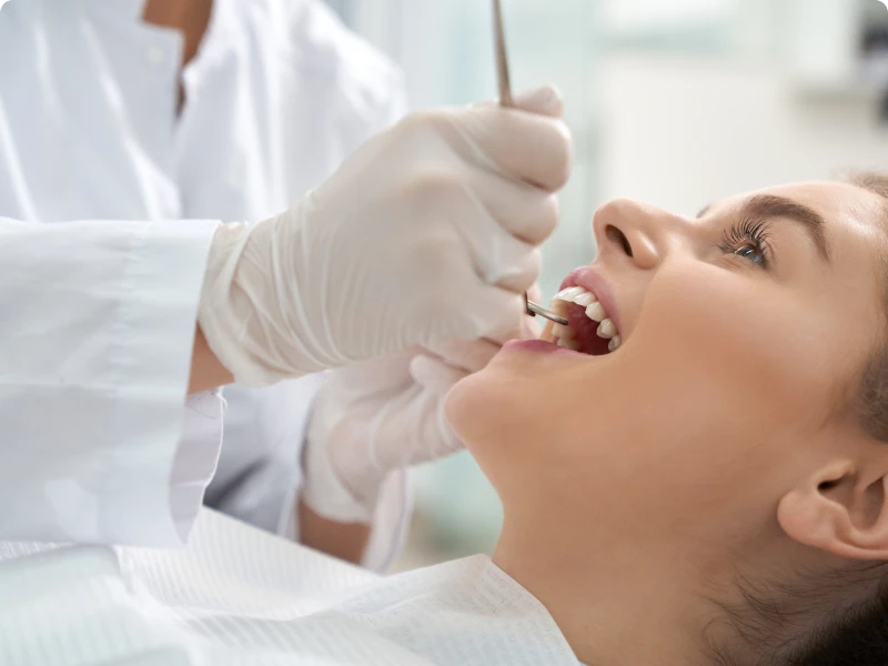 Dentist inspecting patient's teeth